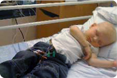 sick child lying in a hospital bed