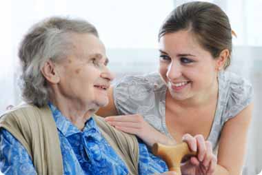 Yound lady comforting elder patient