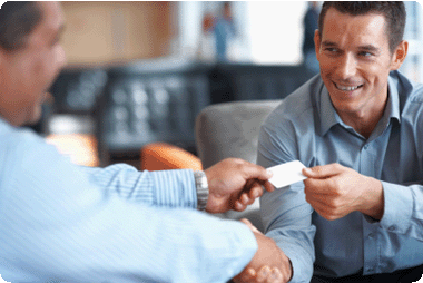 Smiling businessmen exchanging business cards