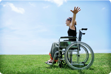 Lady in wheelchair raising her hands with joy