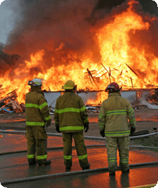 Firemen facing a raging fire