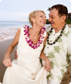 A happy mature couple dancing on the beach
