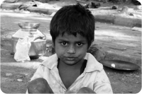 Young boy living rough on dusty streets
