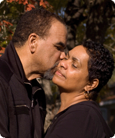 A mature couple embracing in a park