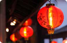 Red Chinese lanterns hanging outside of a property